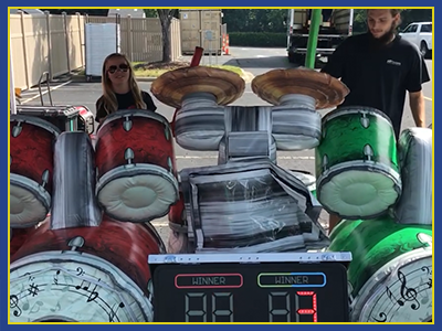 Person behind the drum set interactive game.